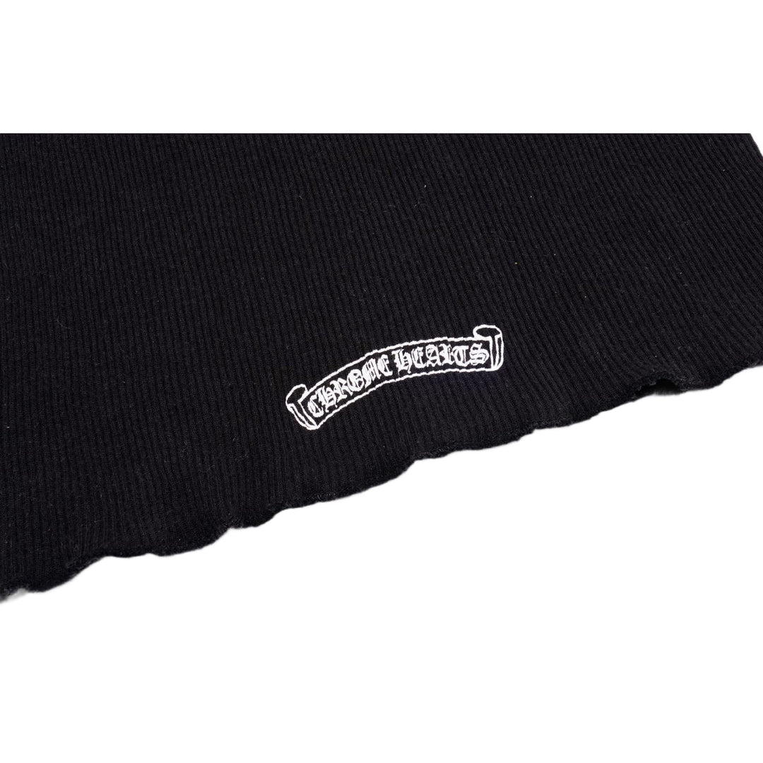 Macro detail of the lower back area, highlighting a small white Chrome Hearts scroll script logo printed cleanly across the ribbed fabric.