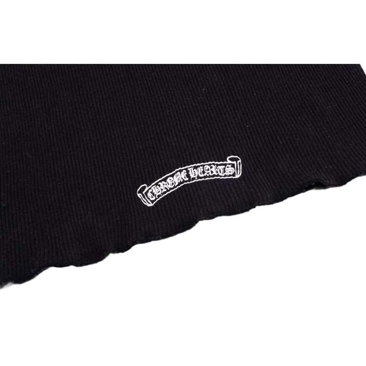 Macro detail of the lower back area, highlighting a small white Chrome Hearts scroll script logo printed cleanly across the ribbed fabric.