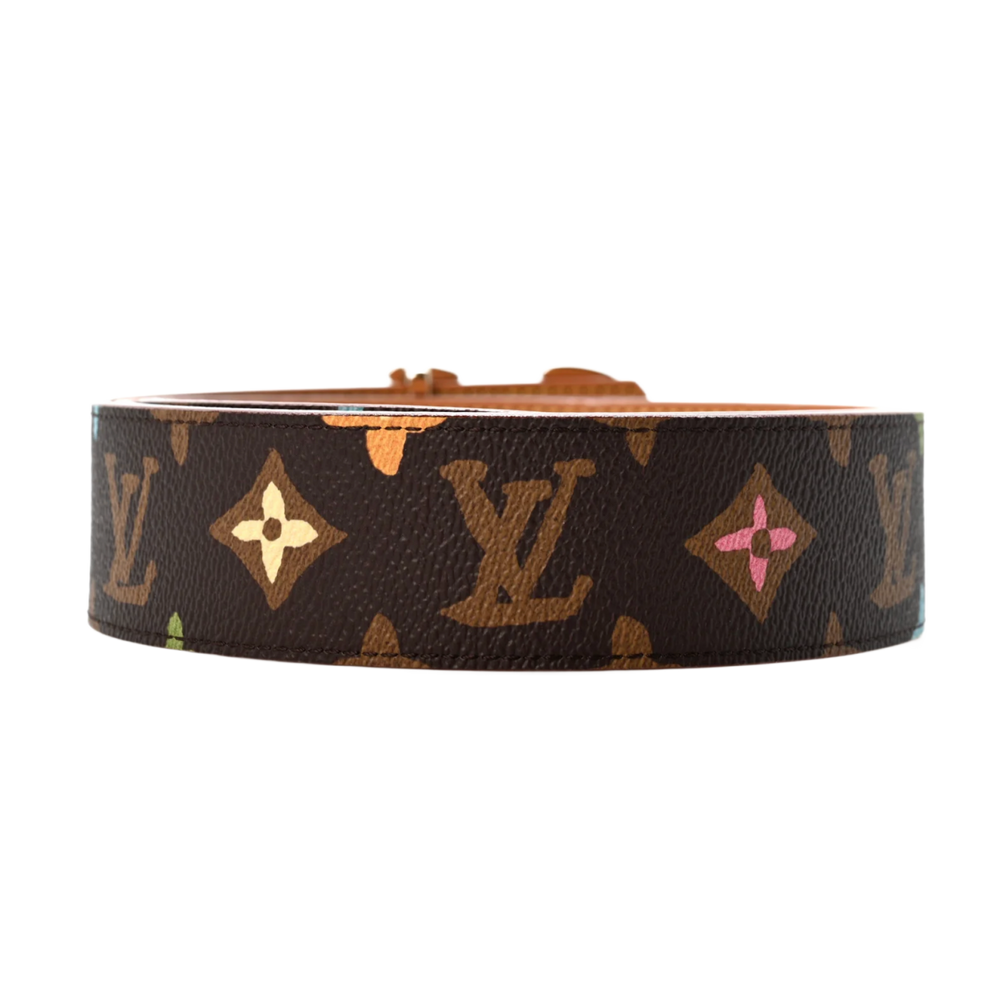 A close-up shot focusing on the folded gold-toned metal LV initials buckle mechanism, highlighting the high-shine polished metallic surfaces, the secure structural hinge rivets, and the neat alignment of the colorful hand-drawn floral motifs flanking the brown coated canvas strap.