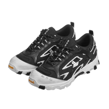 A three-quarter lateral angled layout view of both Sicko Vessel hiking shoes arranged together, emphasizing the aggressive geometric shapes of the high-contrast black and white leather side cages, the thick protective white toe caps, the intricate performance lacing matrix, and the multi-textured durability of the trail design.