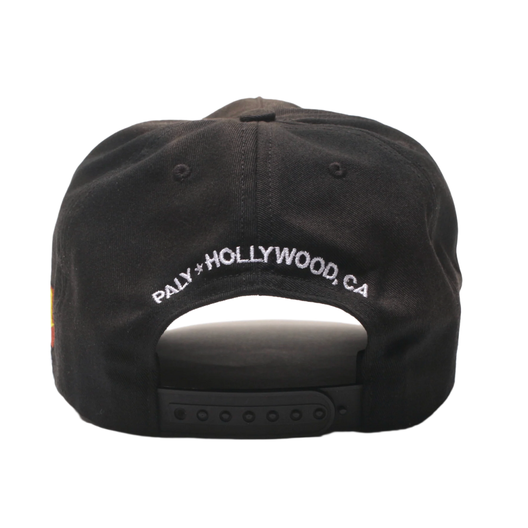 Back view of the Paly washed black hat, showcasing an adjustable fabric strap closure with a silver metal buckle, a curved rear opening, and white embroidered 'PALY HOLLYWOOD, CA' branding curved across the lower back panel.