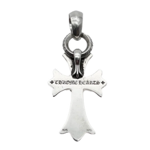 A straight-on view of the reverse side of the sterling silver pendant hanging suspended, highlighting the smooth, high-shine solid backing of the cross limbs, anchored by a prominent engraved signature gothic scroll banner across the horizontal crossbar reading 'CHROME HEARTS'.