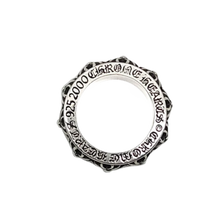 A top-down view looking directly at the circular rim of the sterling silver ring, showcasing the thick outer borders encasing the mechanical spinner core and the uniform circular geometry.