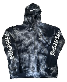 Front flat lay view of the Chrome Hearts zip-up hoodie in a premium heavyweight cotton fleece, showcasing an all-over abstract black and dark grey cloud tie-dye pattern, completed by a high-neck drawstring hood, a silver metal center zipper track, split front kangaroo pouch pockets, and bold white gothic script reading 'CHROME' running down the right lower side torso and 'HEARTS' running up the left lower side torso.
