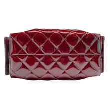 A top-down layout view focusing on the base panel of the Chanel handbag, highlighting the seamless continuation of the diamond-quilted pattern across the bottom surface, clean tonal border stitching, and the flexible grain structure of the glossy burgundy leather.