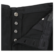 A detailed close-up shot of the open front fly construction, showcasing a vertical row of four polished Chrome Hearts sterling silver buttons engraved with the signature brand motif, alongside a heavy black denim buttonhole placket and interior waistband lining.