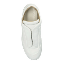 A straight top-down view looking directly into a single white Maison Margiela Future Low sneaker, highlighting the clean hidden-lace configuration, a premium padded white leather interior collar lining, contoured leather insoles, and the brand's iconic minimalist design footprint.