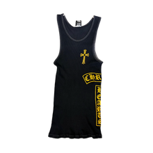 Front flat lay view of the vintage Chrome Hearts sleeveless tank top in a premium fine-ribbed navy blue cotton knit, showcasing a form-fitting athletic silhouette, a deep scoop neckline, a small white graphic printed under the inner back neck, a large bright yellow gothic cross emblem centered on the chest, a curved yellow 'CH' script monogram over the left ribcage, and a bold yellow vertical column of repeating gothic cross graphics cascading down the lower left side torso.