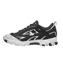 A lateral side profile view of the Sicko Vessel hiking shoe, showcasing a technical trail silhouette with a black mesh upper wrapped in high-contrast white leather and nubuck cage overlays, highlighted by a stylized white embroidered 'S' logo on the side panel, patterned laces, a canvas heel loop, and a thick black midsole stacked on a rugged white outcropping outsole.