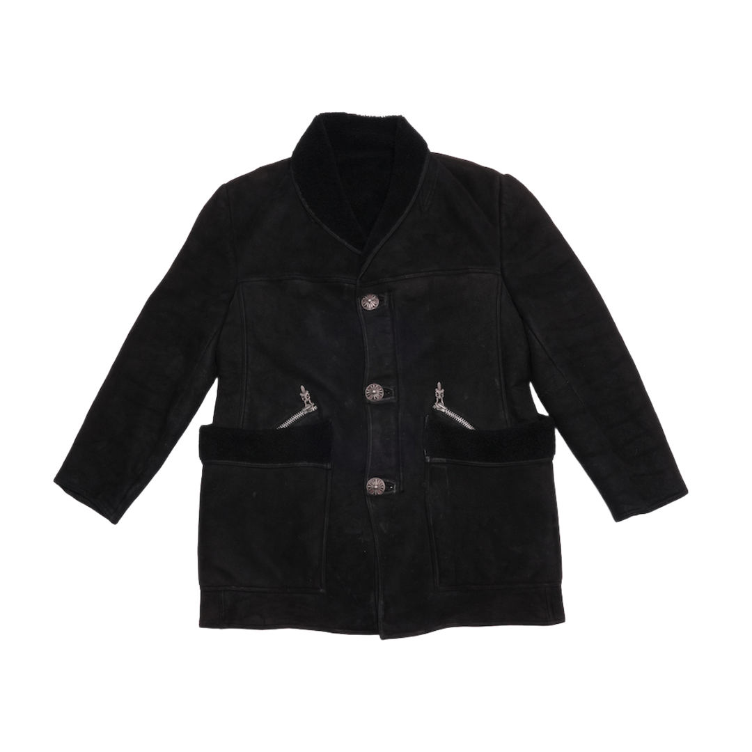 Front flat lay view of the Chrome Hearts shirt jacket in premium matte black nubuck suede leather, showcasing a structured boxy silhouette, a classic pointed collar, large curved patch pockets on the lower front torso, a dual zip-and-button front placket, and raw matte leather seam piping.