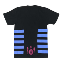 Back flat lay view of the black Chrome Hearts Foti Jarvis t-shirt, showcasing the continuing royal blue horizontal sleeve stripes and a large white horseshoe logo on the lower back framing a small pink skeleton graphic.