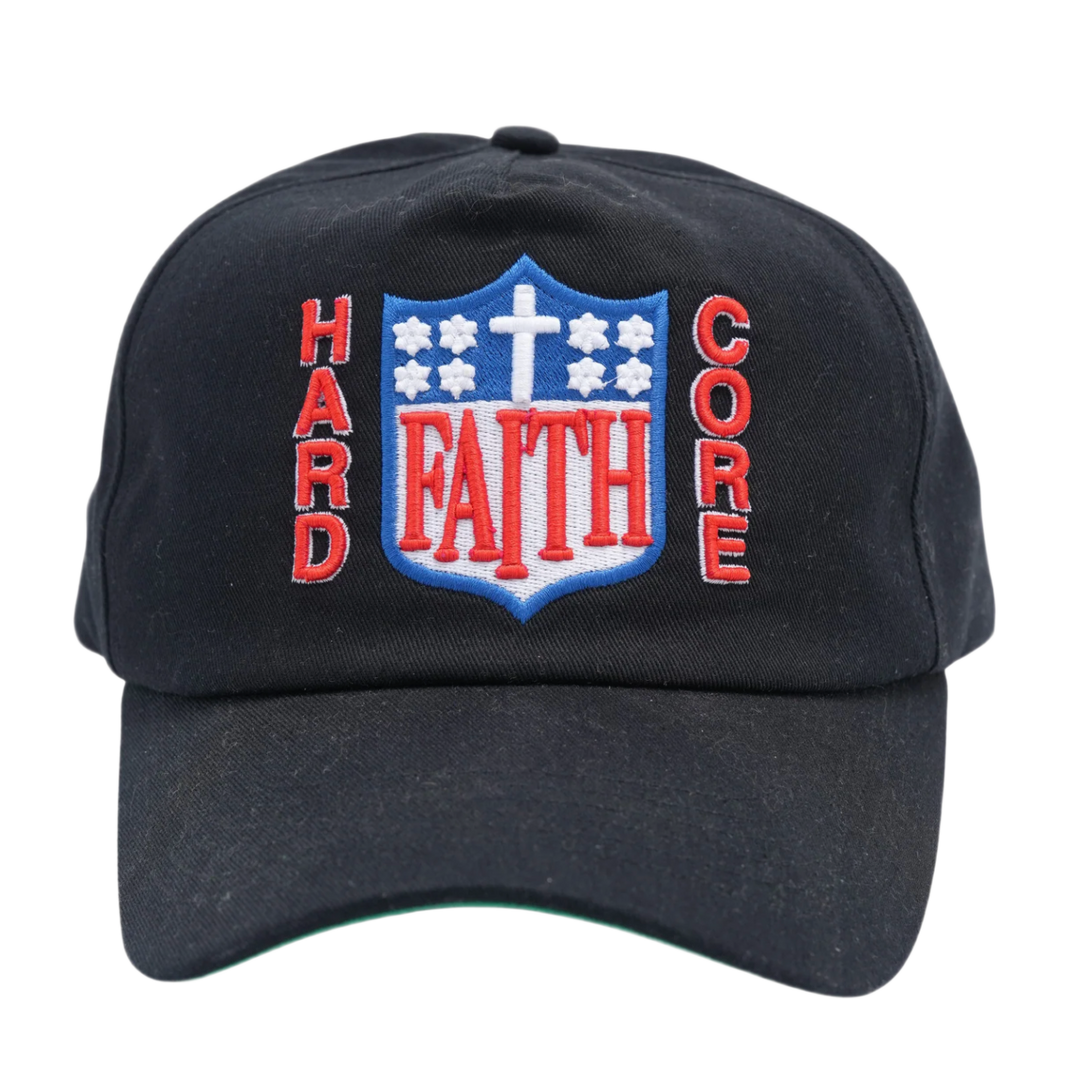 A straight front studio view of the Paly 'Hardcore Faith' hat, showcasing an unstructured six-panel vintage dad hat profile crafted from a premium washed black cotton twill canvas, featuring a curved stitched brim and a bold, dense graphic embroidery layout across the center front crown spelling out 'FAITH' in stylized blue block text flanked vertically by 'HARD' and 'CORE' lettering in red, all centered below a small white embroidered christian cross motif.