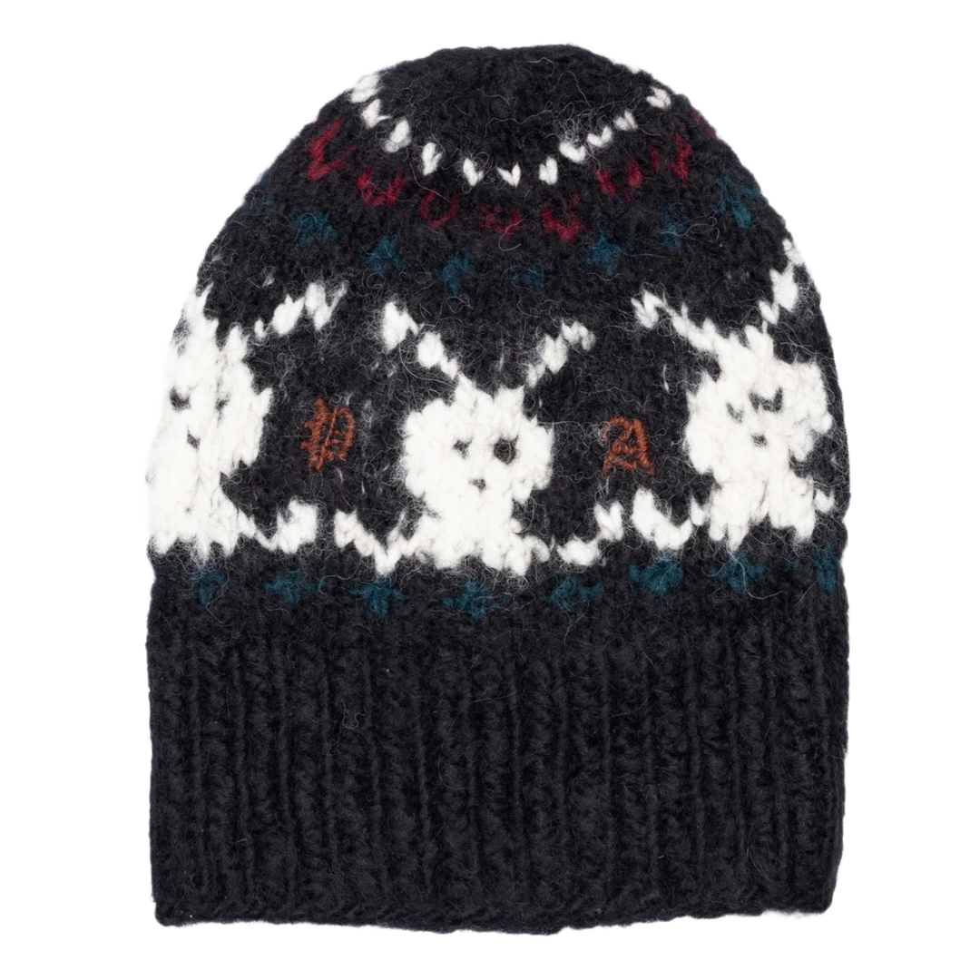 Front studio view of the Paly beanie in a premium heavyweight hand-knitted wool blend, showcasing an intricate Fair Isle style intarsia knit construction featuring rows of white, dark navy, and burgundy red geometric snowflake patterns, balanced by a wide fold-over black rib-knit cuff decorated with a repeating pattern of white contrast-knit bunny rabbit motifs wrapping smoothly around the center front crown.