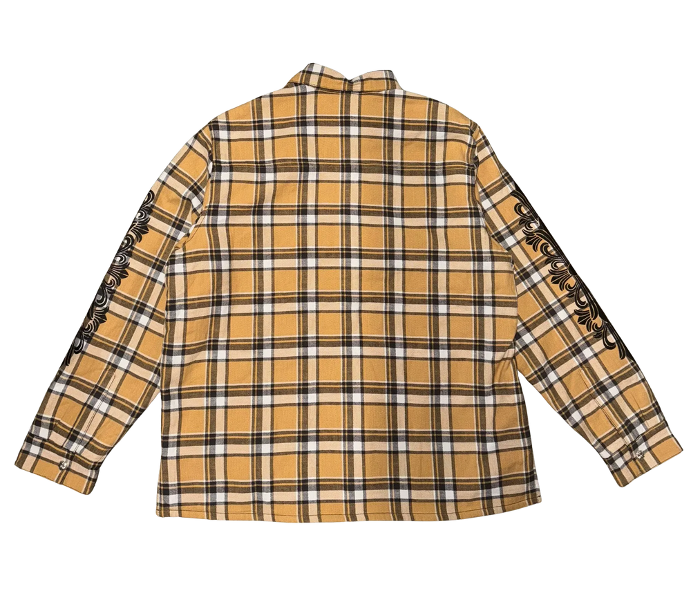 Back flat lay view of the tan plaid Chrome Hearts flannel shirt jacket, highlighting the clean pattern alignment across the rear yoke and lower back panels, dominated by a large, intricate black screen-printed graphic emblazoned across the upper back torso depicting a circular horseshoe layout of signature brand lettering framing an oversized gothic floral cross design motif.