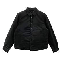 Front flat lay view of the Chrome Hearts shirt jacket in structured black canvas cotton, featuring a classic pointed collar, a button-down front closure, a curved hemline, and tonal patch pockets on the chest.