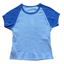 Front flat lay view of the vintage Chrome Hearts women's baby tee in a soft cotton stretch jersey, showcasing a classic cropped y2k silhouette with a two-tone blue colorblock layout, featuring a light powder blue main body contrasted by deep royal blue short raglan sleeves, a matching royal blue crewneck collar band, and a clean solid front torso panel.