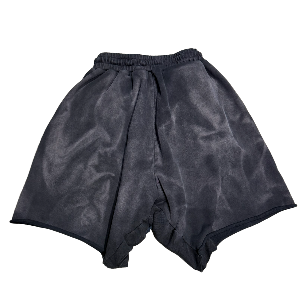 Back flat lay view of the faded black Rivington roi Rebis lounge shorts, highlighting the premium heavy fleece fabric draping across a relaxed silhouette, with a comfortable gathered elastic waistband and a clean, unadorned solid charcoal-toned reverse profile running to the wide raw-edge lower hems.