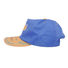 A right-side profile view of the blue and cream cap, highlighting the uniform contour of the bill and the vintage washed fabric texture across the side panels against a white background.