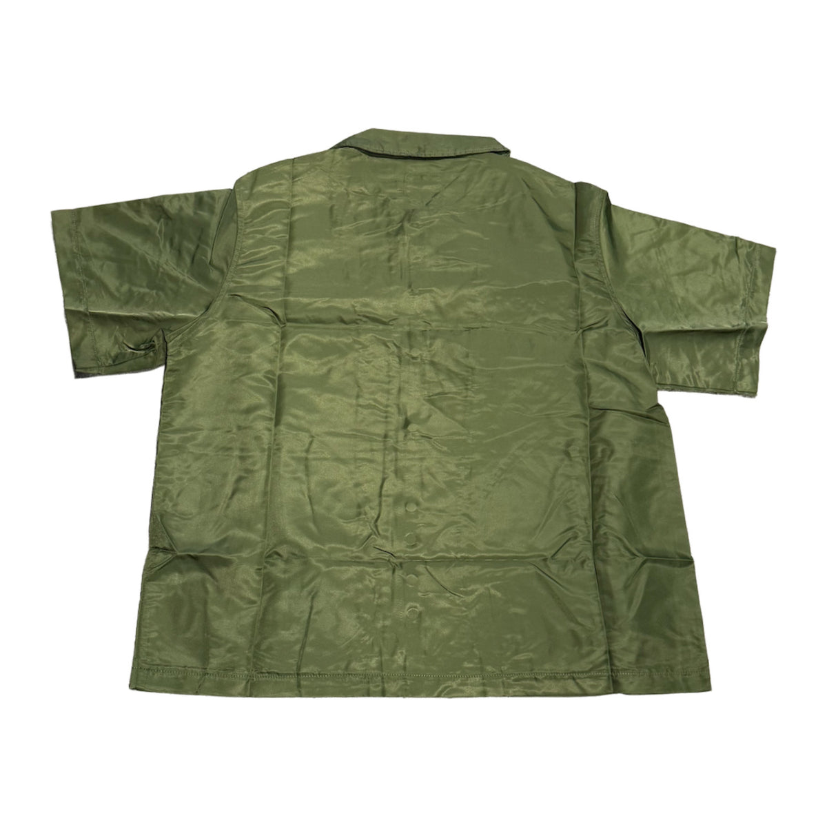Back flat lay view of the olive green Saint Vanity technical nylon short-sleeve shirt, highlighting the crisp structural draping, a straight horizontal shoulder yoke seam running across the upper back panel, and a clean, solid unadorned matte green fabric profile.