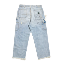 Back flat lay view of the light blue Paly ripped studded jeans, showcasing a relaxed silhouette with minor fading on the seat, a small leather brand patch on the waistband, and clean patch pockets.