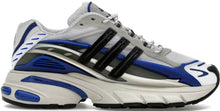 A lateral side profile view of the adidas Adistar Jellyfish Pharrell Williams sneaker, featuring a breathable silver mesh base with white leather overlays, classic black three-stripes branding, and dramatic royal blue technical pods wrapping around the midsole and heel.