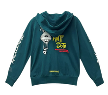 Front flat lay view of the Chrome Hearts x Matty Boy 'Antidote' zip-up hoodie in a premium heavyweight teal-green cotton fleece, showcasing a structured boxy streetwear silhouette, a high-neck drawstringless hood, a polished silver metal center zipper track, split front kangaroo pouch pockets, a yellow and black collaborative cartoon checkerboard motif printed on the left chest, and bold white gothic script reading 'CHROME' down the right sleeve and 'HEARTS' down the left sleeve in a heavy screen-print.