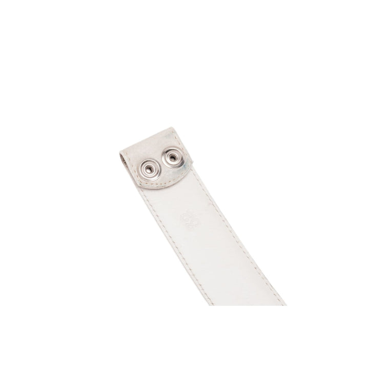 Close-up view of the belt strap tip, showcasing two signature Chrome Hearts sterling silver snap buttons detailed with ornate gothic floral cross motifs.