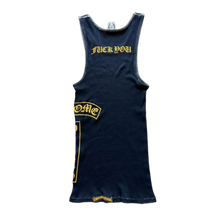 Back flat lay view of the navy blue vintage Chrome Hearts tank top, highlighting the classic racerback or T-bar shoulder construction that narrows elegantly across the upper spine, dominated by an arched bright yellow gothic script brand logo screen-printed cleanly across the shoulder blade panel.