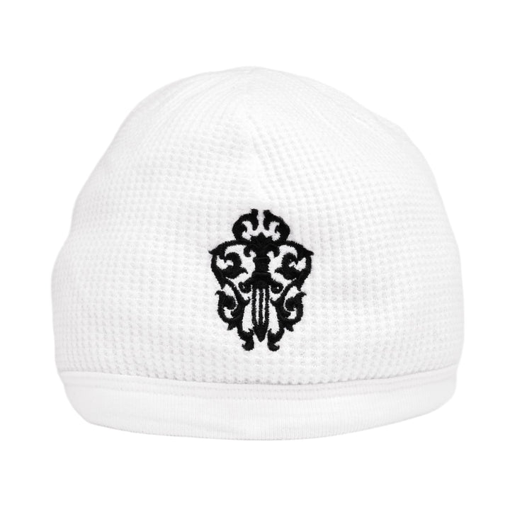 Front flat lay view of the Chrome Hearts vintage skull cap beanie in white thermal waffle-knit cotton, featuring a bold black gothic vine dagger graphic centered on the front cuff.