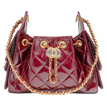 Front studio view of the Chanel Hobo 25 handbag, showcasing a structured slouchy silhouette crafted from a premium shiny calfskin leather in a rich dark burgundy hue, enveloped in classic diamond quilting patterns, detailed with dual interwoven gold-tone metal and leather shoulder straps, and a prominent oversized gold metal CC turn-lock emblem centered on the front face.