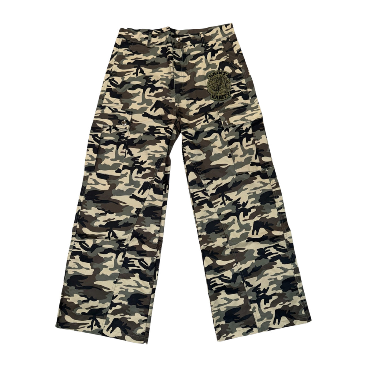 Front flat lay view of the Saint Vanity cargo pants in a textured woodland camouflage nylon fabric, showcasing a relaxed straight-leg utility silhouette, an integrated elastic waistband, deeply inset side slip pockets, and low-profile rectangular cargo utility pockets stitched along both outer thighs with a small contrasting green embroidered patch applied to the left pocket flap.