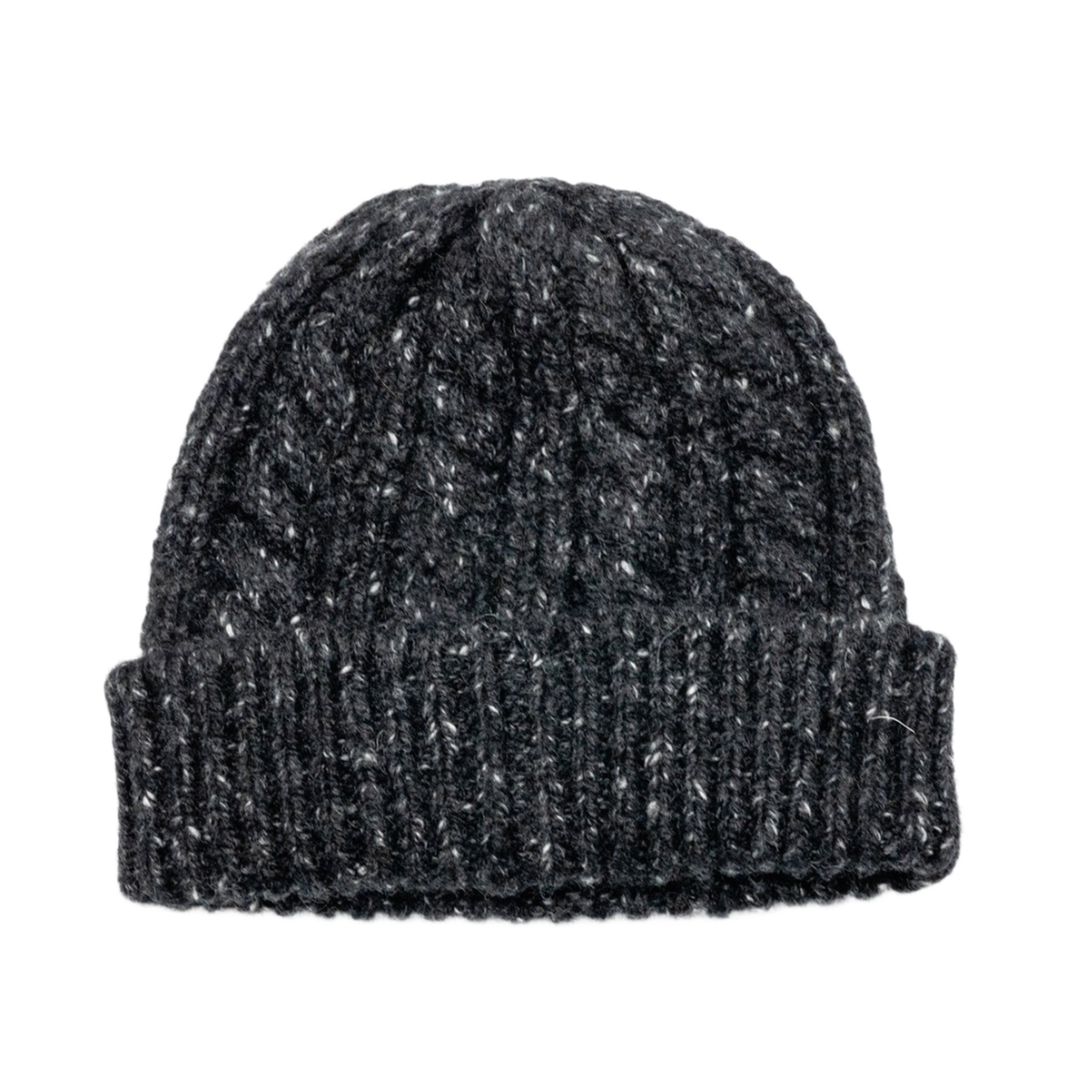 A clean profile layout view of the black and ecru Chanel knit cashmere beanie resting upright, highlighting the dense multi-directional cables and chunky ribbed texture tapering cleanly upward to a four-point crown closure, with a solid unadorned rear profile.