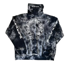 Back flat lay view of the tie-dye Chrome Hearts fleece hoodie, highlighting the relaxed boxy streetwear drape, matching cloud-like abstract grey bleach patterns running uniformly across the back panel, and a massive circular white signature horseshoe logo graphic printed boldly across the center back torso.