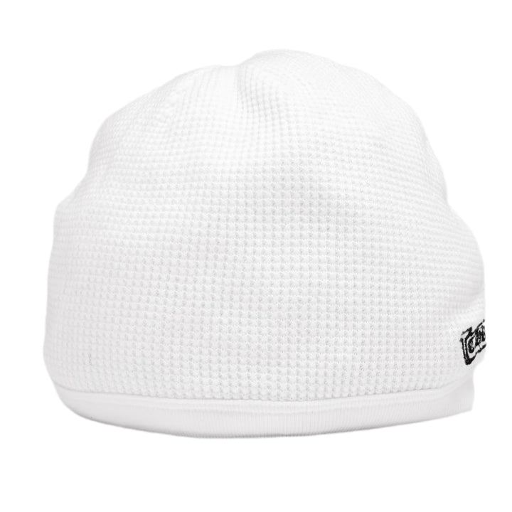 Back view of the white Chrome Hearts thermal skull cap, displaying a small black gothic emblem printed near the lower right edge of the clean, unadorned white waffle panels.