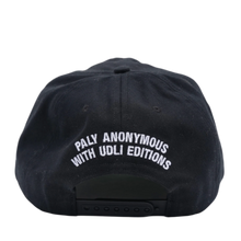A straight-on rear view of the black Paly 'Hardcore Faith' canvas cap resting flat, highlighting the low-profile crown posture and uniform panels, featuring a adjustable fabric strap closure with a metallic slider buckle, accented cleanly by a curved white embroidered text graphic stitched across the rear opening arc.