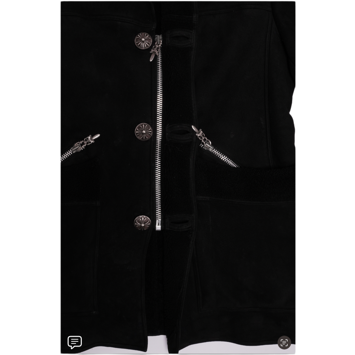 A close-up view of the open front placket and interior lining, showcasing a heavy metallic silver dagger zipper track running parallel to polished metal button snap closures, offset by a rich, thick black plush shearling fur interior body lining.