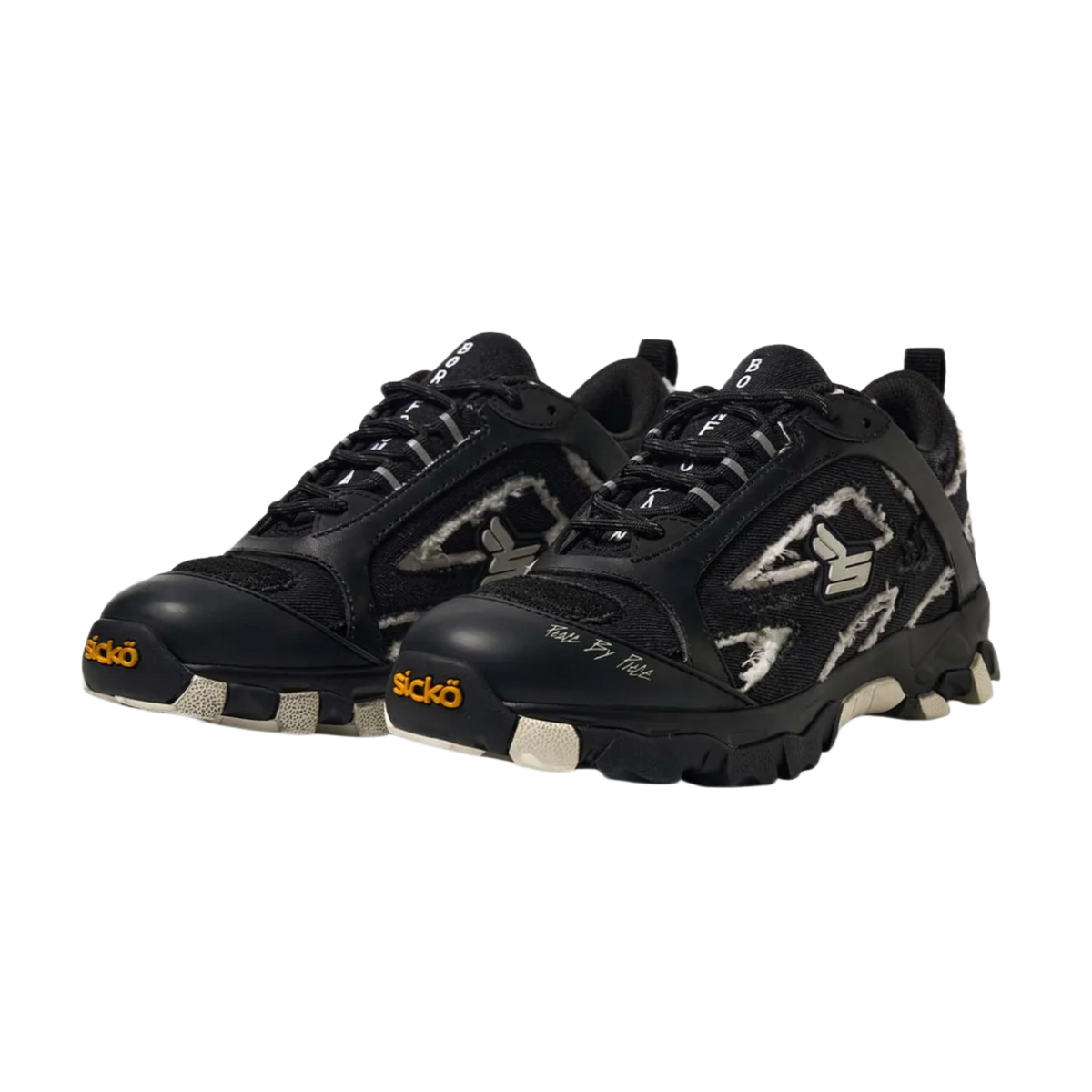 A three-quarter lateral angled layout view of both black Sicko Vessel hiking shoes arranged together, emphasizing the aggressive geometric shapes of the layered side panels, the protective toe cap bumpers, the complex technical lacing matrix, and the dense, multi-textured performance materials used across the upper design.
