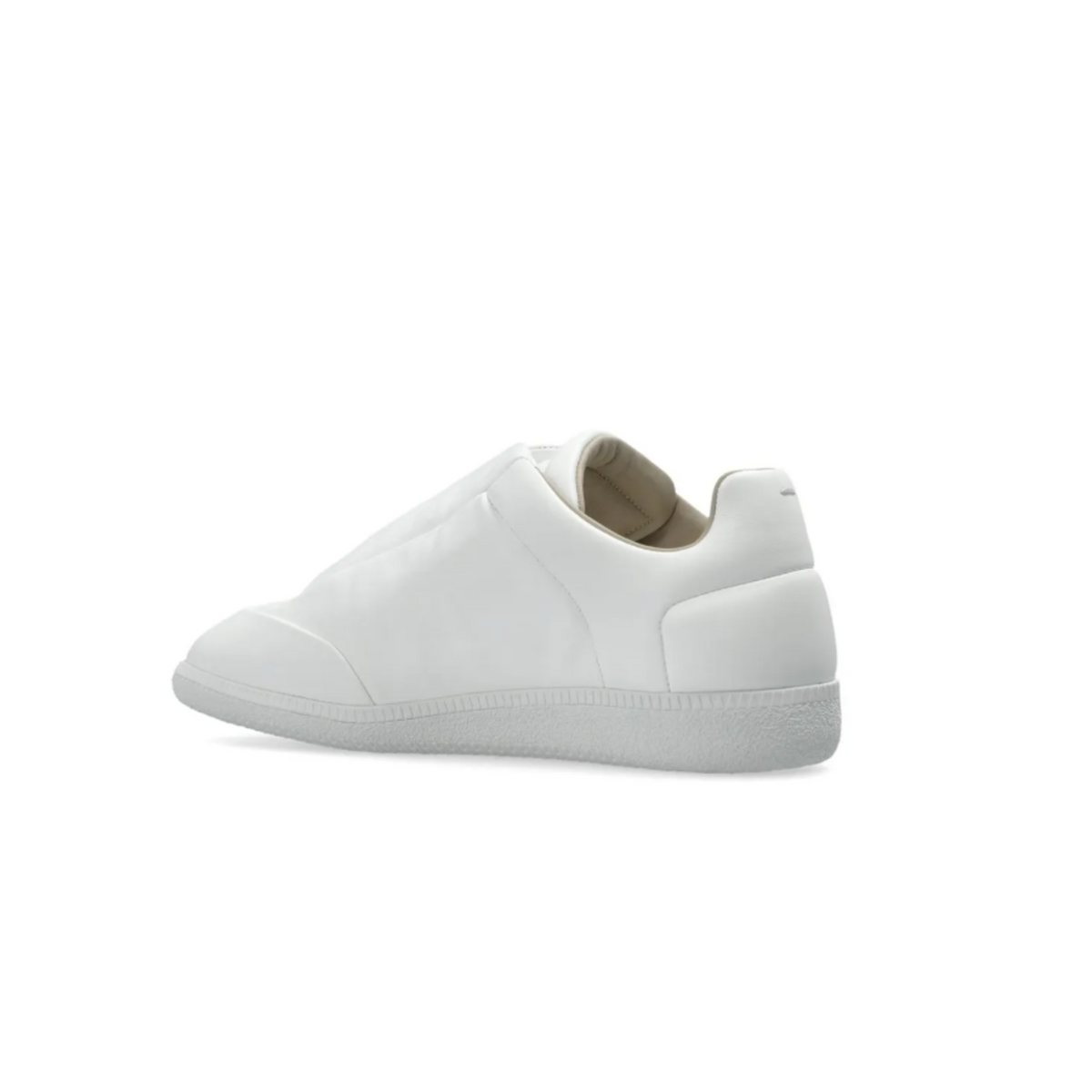 A flat medial side profile view of the white leather sneaker, emphasizing the seamless, unadorned structural panel design stretching across the inner foot walls, the geometric precision of the leather overlay sections, and the uniform tone of the matching white cupsole.