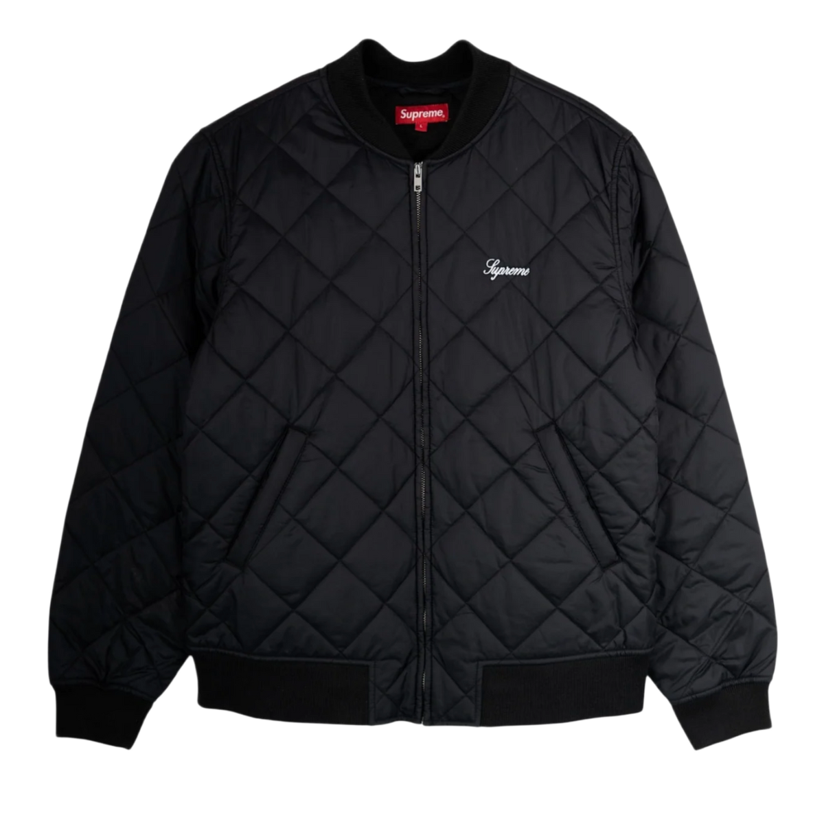 Front flat lay view of the Supreme bomber jacket in a jet-black technical satin shell, showcasing a structured street silhouette defined by a uniform diamond-quilted insulated construction, a ribbed knit baseball-style collar, a silver metal center zipper track, angled lower double-welt hand pockets, matching thick ribbed knit cuffs and hemline, and a small elegant white cursive Supreme script logo embroidered cleanly on the left chest.