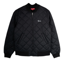 Front flat lay view of the Supreme bomber jacket in a jet-black technical satin shell, showcasing a structured street silhouette defined by a uniform diamond-quilted insulated construction, a ribbed knit baseball-style collar, a silver metal center zipper track, angled lower double-welt hand pockets, matching thick ribbed knit cuffs and hemline, and a small elegant white cursive Supreme script logo embroidered cleanly on the left chest.
