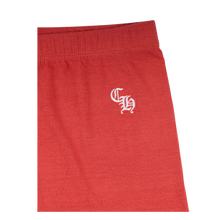 Back flat lay view of the red Chrome Hearts women's biker shorts, highlighting the sleek minimalist compression tailoring, an unadorned reverse panel layout that emphasizes the uniform performance textile drape, and clean structural flatlock edge stitching running across the secure lower thigh leg hems.