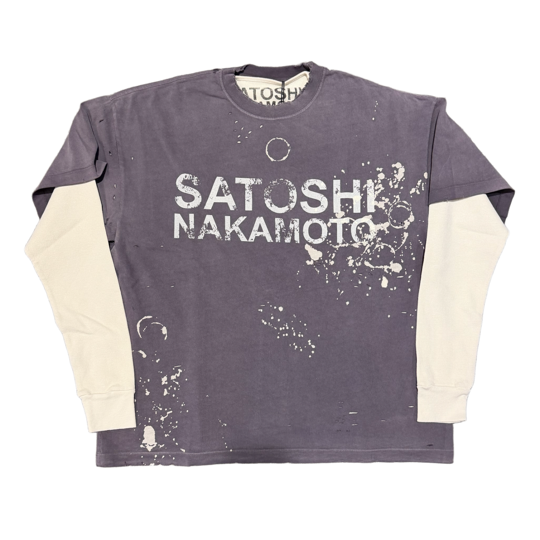 Front flat lay view of the Satoshi Nakamoto 'Luke' long-sleeve top, showcasing a unique double-layer design featuring a distressed short-sleeve faded purple graphic t-shirt layered over cream-colored waffle-knit thermal long sleeves, detailed with bold white printed branding reading 'SATOSHI NAKAMOTO' across the chest, heavy contrast white stitching, and a vintage-washed bleached paint pattern along the lower torso.
