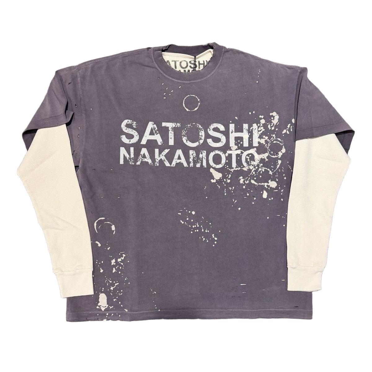 Front flat lay view of the Satoshi Nakamoto 'Luke' long-sleeve top, showcasing a unique double-layer design featuring a distressed short-sleeve faded purple graphic t-shirt layered over cream-colored waffle-knit thermal long sleeves, detailed with bold white printed branding reading 'SATOSHI NAKAMOTO' across the chest, heavy contrast white stitching, and a vintage-washed bleached paint pattern along the lower torso.