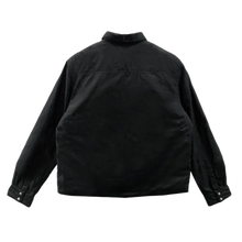 Back flat lay view of the black Chrome Hearts shirt jacket, showcasing the clean boxy outerwear silhouette with an unadorned solid black canvas panels across the shoulders and lower back.