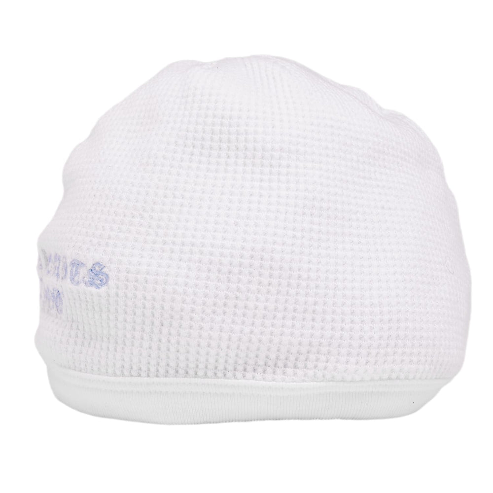 A front left angled view of the white skull cap beanie, showcasing how the light blue gothic lettering wraps seamlessly around the side profile of the tight-fitting crown.