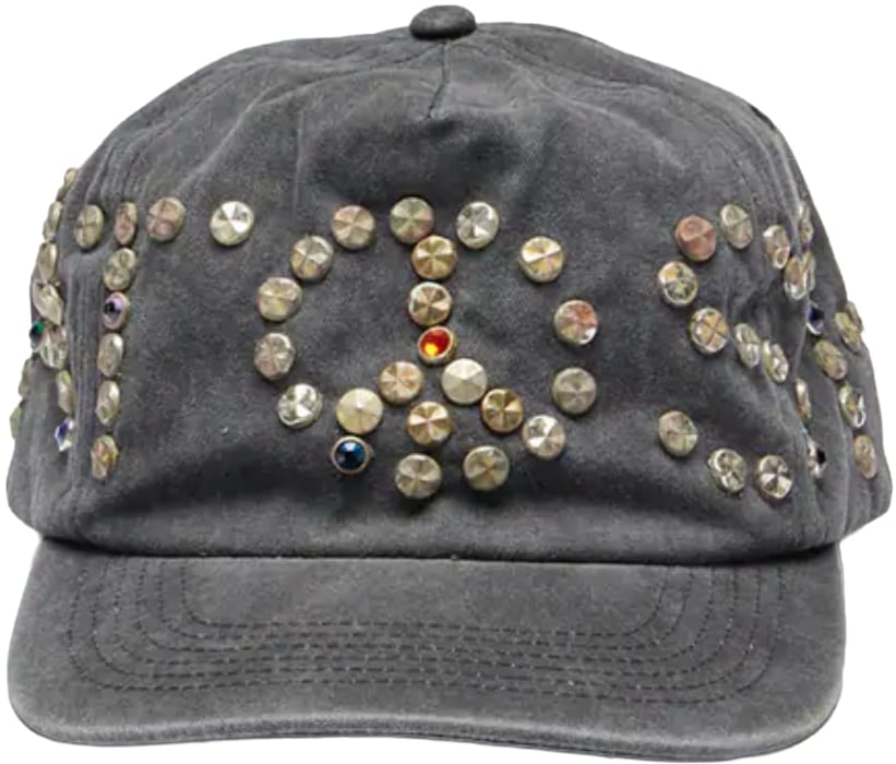 Front view of the Satoshi Nakamoto hat in a heavily washed charcoal grey cotton canvas, featuring a dense cluster of multi-sized circular metal studs in antique bronze, brass, and silver scattered across the front panels.