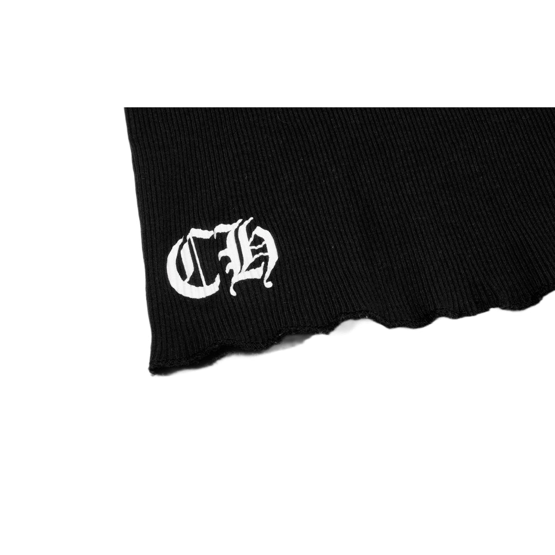 Close-up detail of the lower front hem, showcasing the tight white embroidery of the stylized gothic 'CH' monogram against the black ribbed cotton canvas.