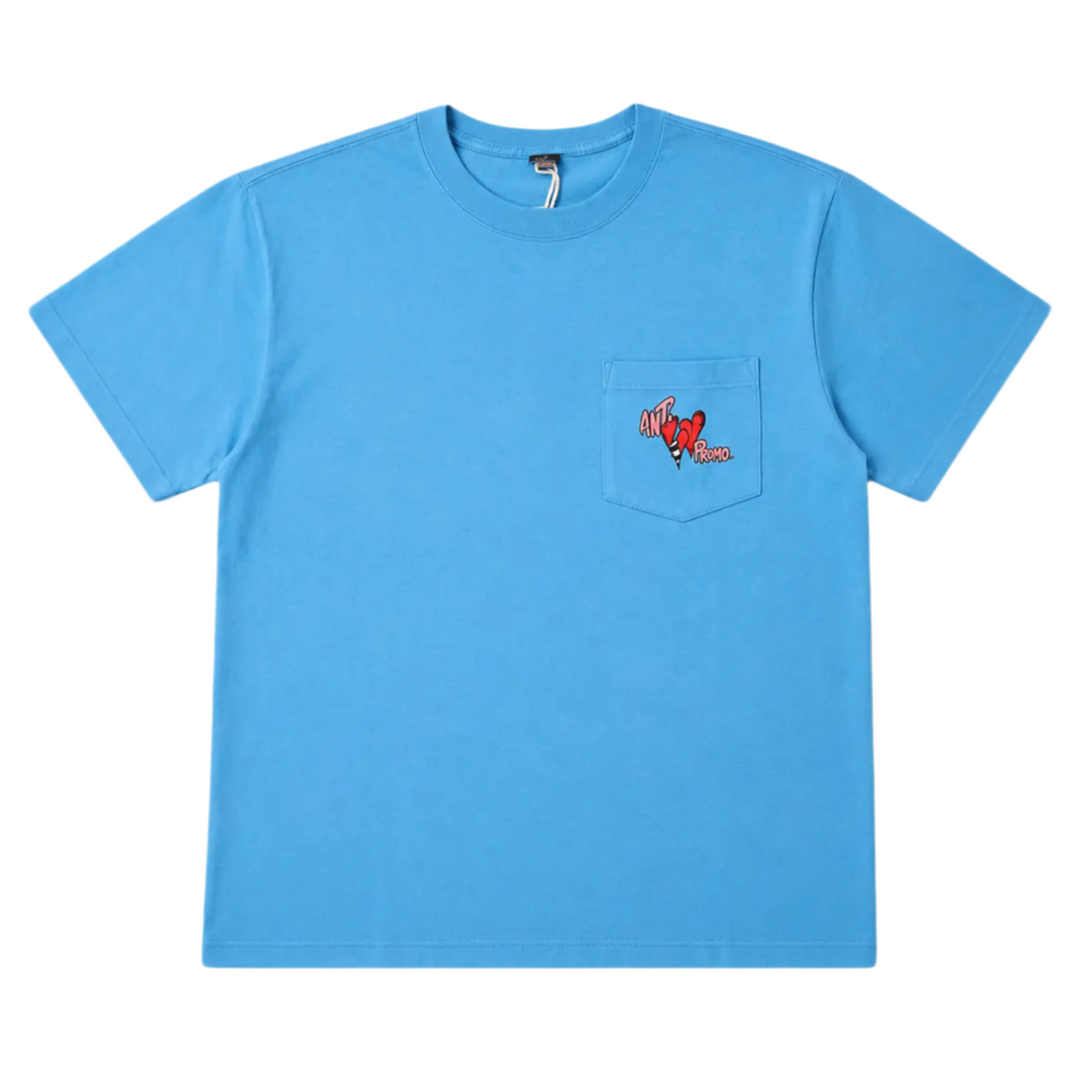 Front flat lay view of the Matty Boy Anti Promo short-sleeve t-shirt in vibrant blue cotton, featuring a classic crew neck, a single patch pocket on the left chest, and a small red hand-drawn cartoon character graphic peeking over the top of the pocket.
