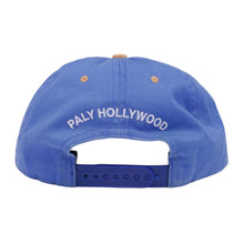 Back view of the blue Paly Hollywood cap, showcasing an adjustable blue plastic snapback enclosure, a curved rear opening, and clean canvas panels tapering up to the top button.