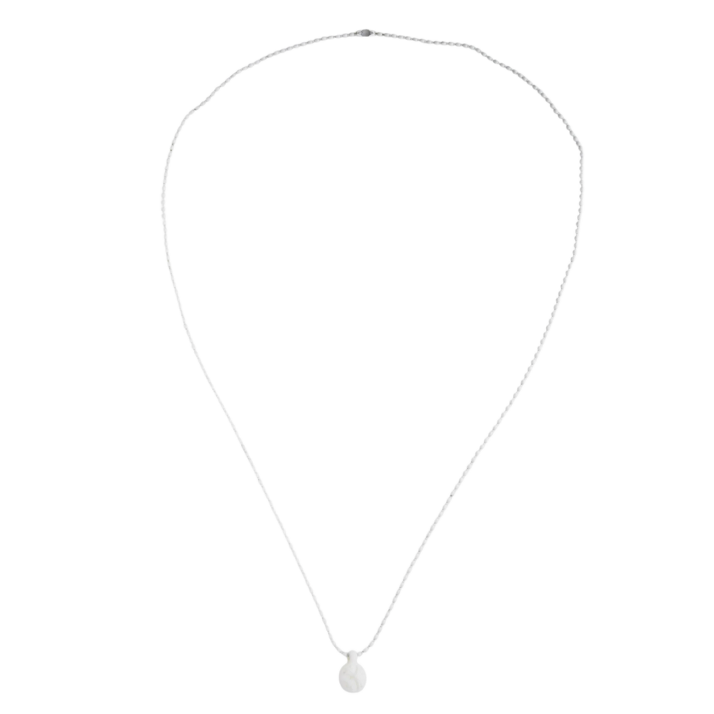 A top-down view of the white silicone Chrome Hearts necklace laid out in a wide teardrop loop, displaying the flexible, seamless structure of the modern lightweight crossball chain.